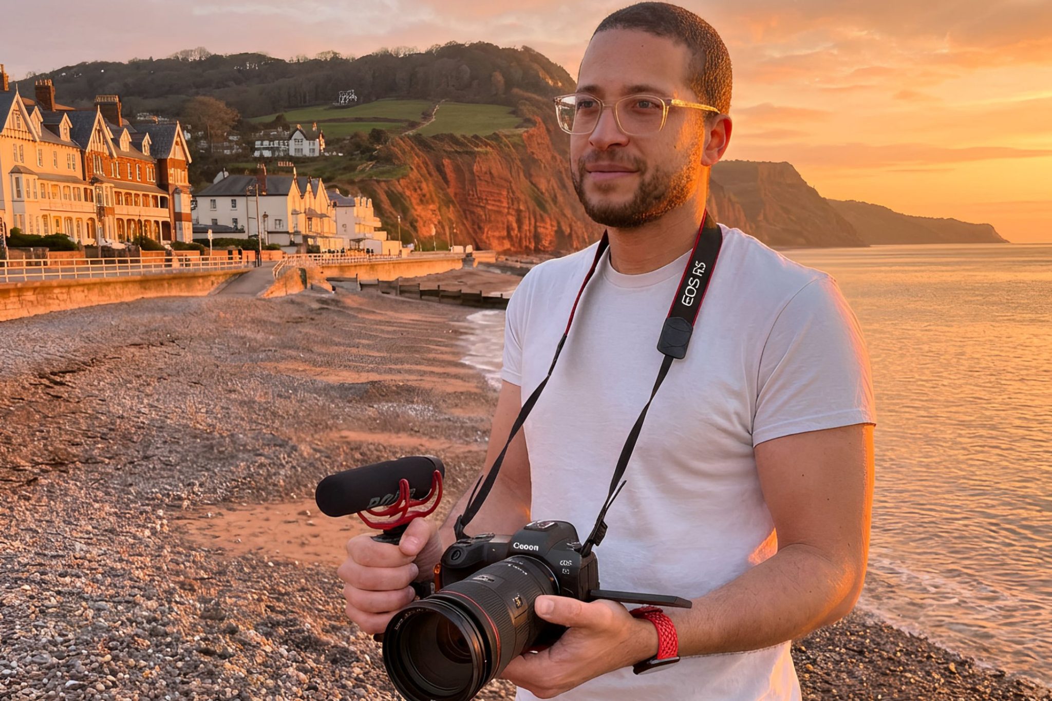 Sean Brown with his camera on the beach at sunset